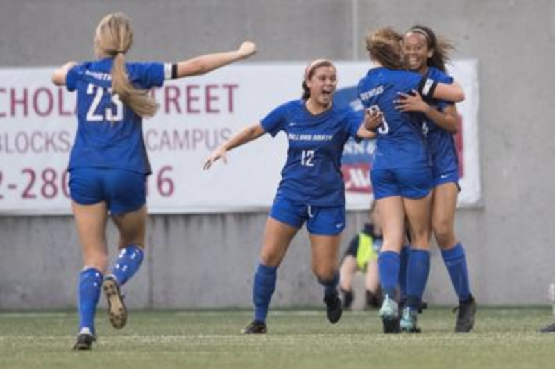 KICKING OUT COMPETITION: Last years girls soccer team jump up and down with joy as they fight their way into finals