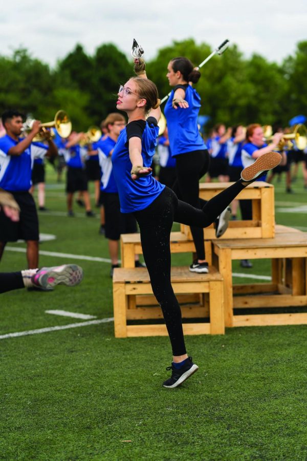 Junior Calista Rittershaus prances across the football field. Color guard has serparate practices from the marching band.