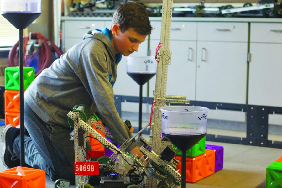 Freshman Patrick Stolinski makes adjustments to his teams robot. Stolinski plans to take a Robotics class next year.