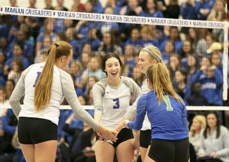 (left to right) Senior Mckenna Ruch, junior Mollie Fee, senior Lauren Maciejewski, and sophomore Kate Galvin high five after they score on Marian. Millard North won the game 3-2.