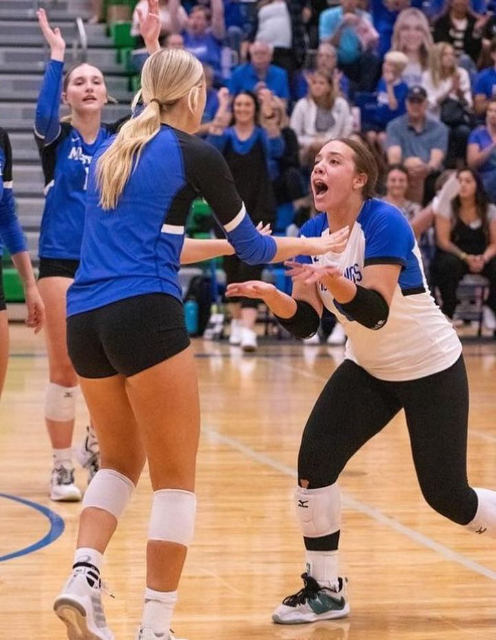 Meet Me At The Net:
Kucks and fellow teammate Rilyn Gish share a special moment as they celebrate the good play they made.