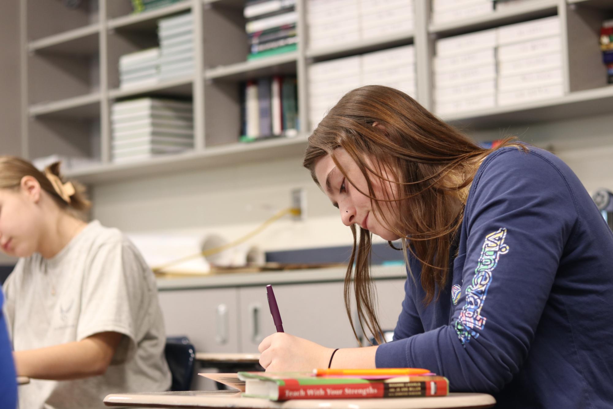 Rowyn Wiltgen, Millard South junior and Education Academy student, writes a meaningful letter to a teacher who has had an impact on her life and academics. This is just one of the types of activities academy students partake in every day.