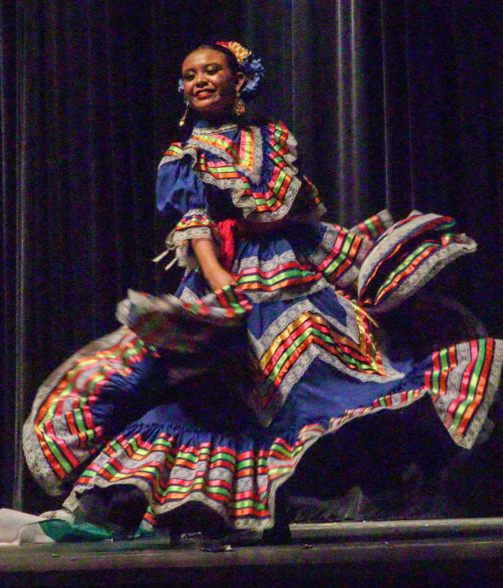 In a customary Mexican dance, a participant at "Tapestry of Travels" twirls and dances to the upbeat, traditional music of Mexican culture. The particular culture and performance was just one of the many celebrated at "Tapestry of Travels."