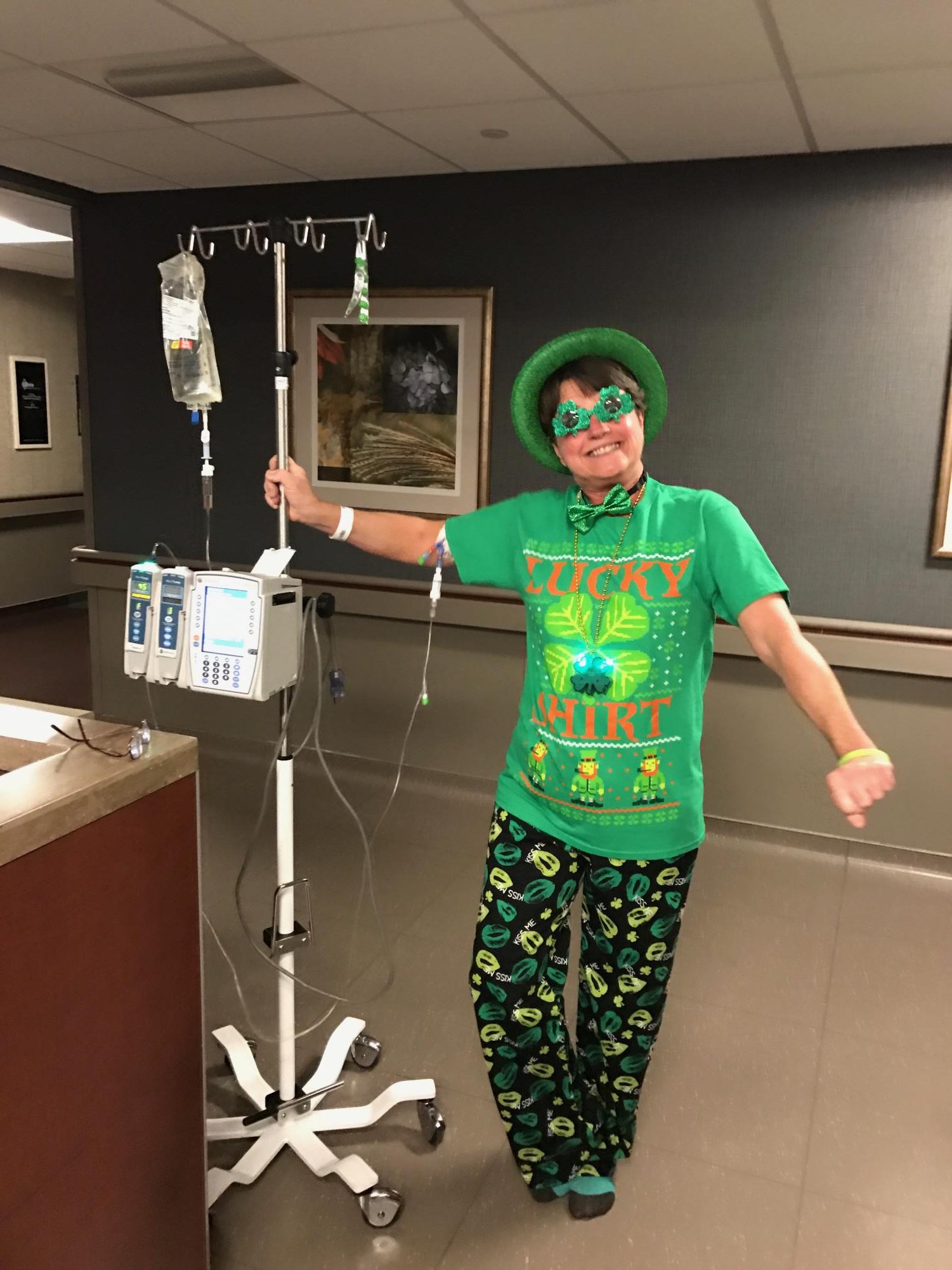 Kathy Folk stands decked out in green during treatment on St. Patricks Day. She is not only wearing green for the holiday, but also for non-Hodgkin's awareness