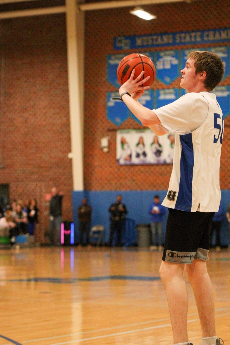 Sophomore athlete Matthew Hulsebusch shoots the ball during the MN pep rally. His favorite part of the program is being around his friends and improving together.